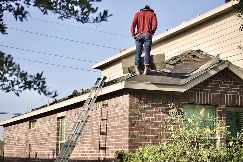 Professional roofer working on a residential roof in Smithtown